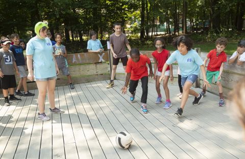 A group playing a ball game at camp