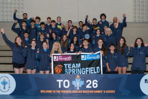 A photo of Team Springfield holding its banner