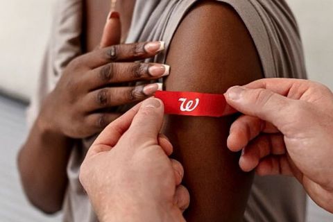 Applying a band aid after a vaccination