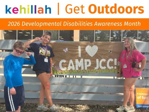 A camper and two counselors pose next to a sign reading I love Camp JCC