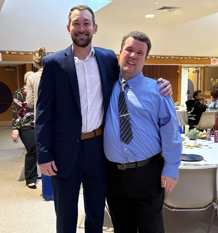 two men standing together at a party