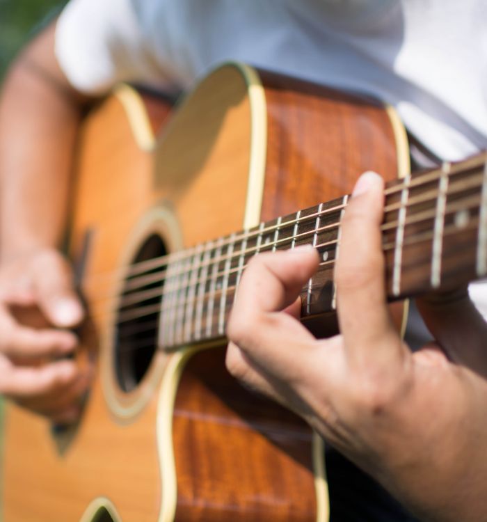 a close-up of a person playing a guitar