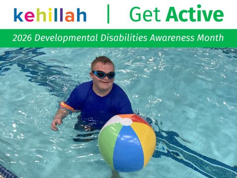A young man in a swimming pool playing with a beach ball