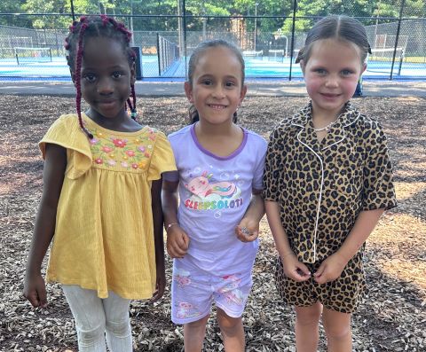 three girls outside at camp